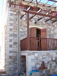 View of the terrace, pergola and wooden shutters