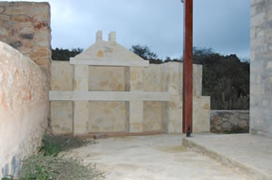 Outside kitchen area with BBQ and wash basin (obscured by pergola support)