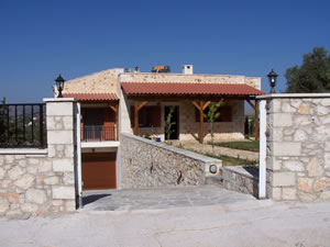 Split level stone villa with boundary wall.