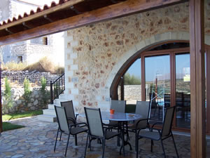 Covered rear patio with arch window feature.