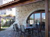 Covered rear patio with arch window feature.