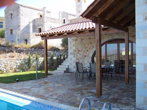 Covered rear patio with arch window feature.