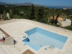 Pool and extensive stone patio area and boundary wall