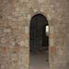 Arched dooway and exposed stonework.