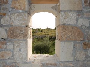 Arched window and exposed stonework.